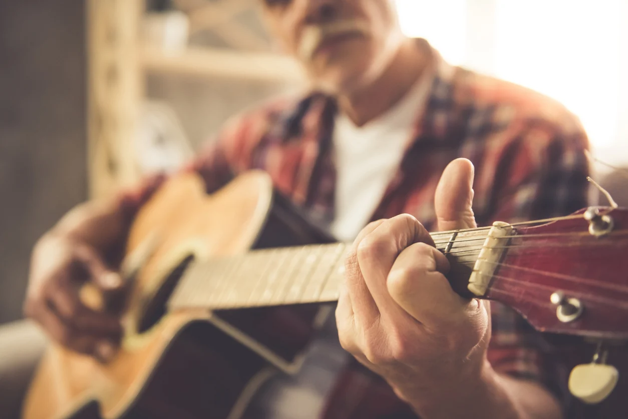 an older man playing guitar