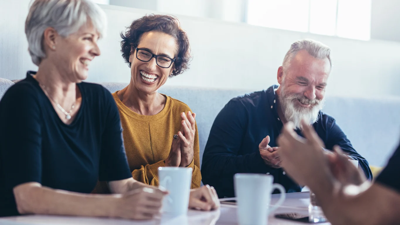 Group of mature adults having coffee