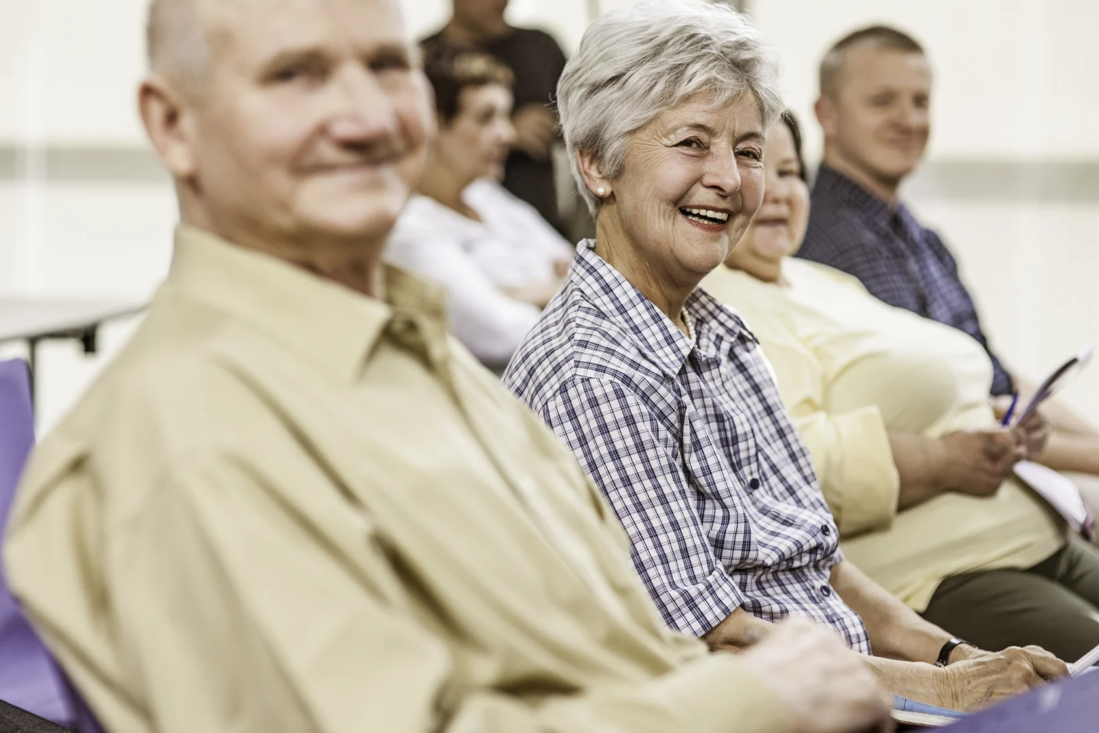 group of older adults seated watching someone out of frame